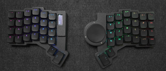 Parix 52 split keyboard, both halves top-down, black shine-through keycaps with per-key RGB, OLED on the left half, trackpad on the right