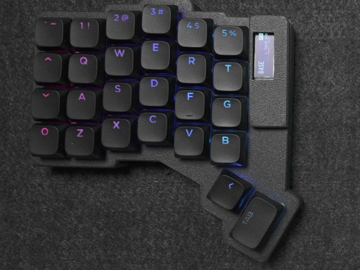 Parix 52 left half, top-down: six columns, four rows and two thumb keys, black shine-through keycaps, small OLED