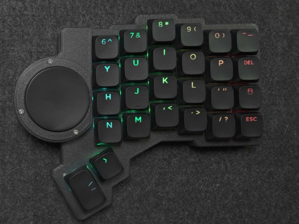 Parix 52 right half, top-down: 40 mm Cirque trackpad on the inner edge beside the keys, black shine-through keycaps