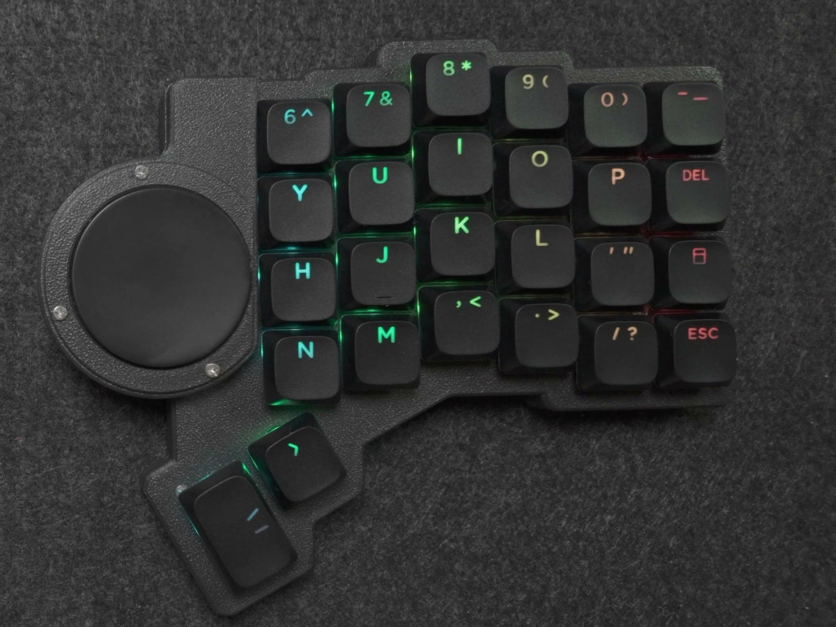 Parix 52 right half, top-down: 40 mm Cirque trackpad on the inner edge beside the keys, black shine-through keycaps