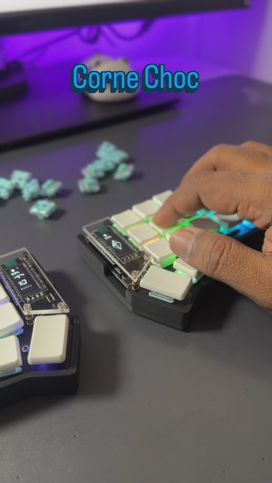 Corne Choc low profile split keyboard showing OLED screen and RGB lighting
