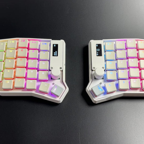 Per-key RGB cycling across the white Sofle Choc split keyboard's translucent keycap legends