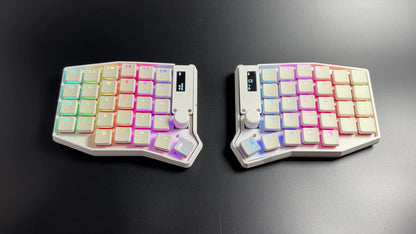 Per-key RGB cycling across the white Sofle Choc split keyboard's translucent keycap legends